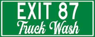 The image displays a green and white sign for EXIT 87 Truck Wash.