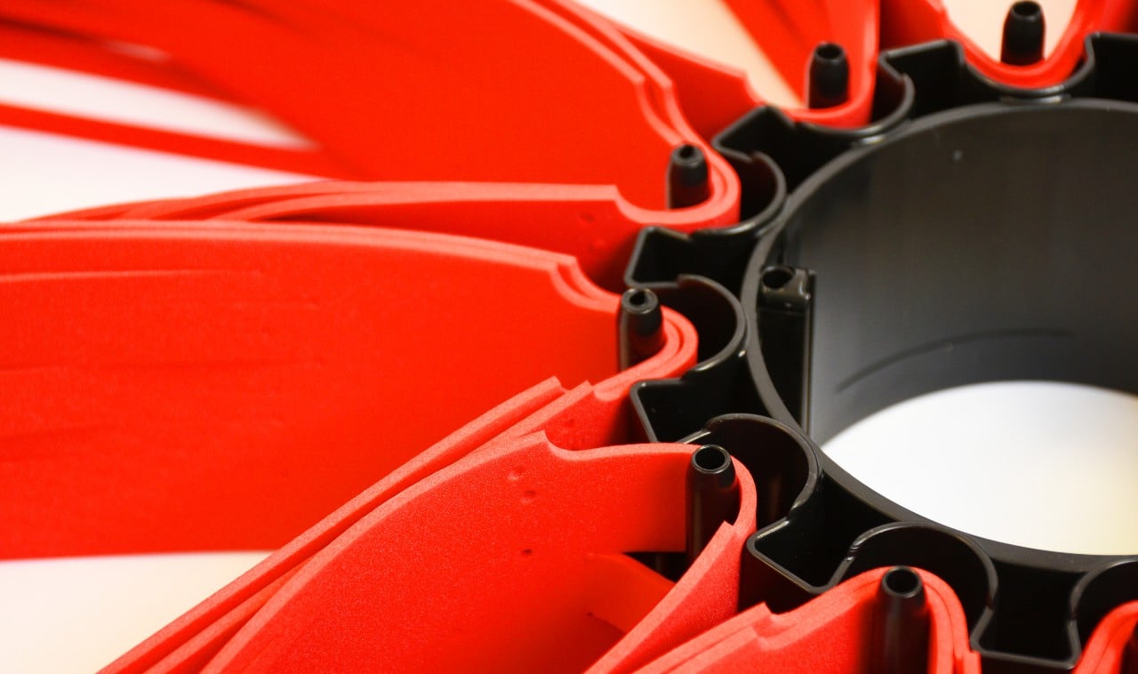 Close-up of red plastic objects with a circular black structure, possibly parts of a fan or machinery.